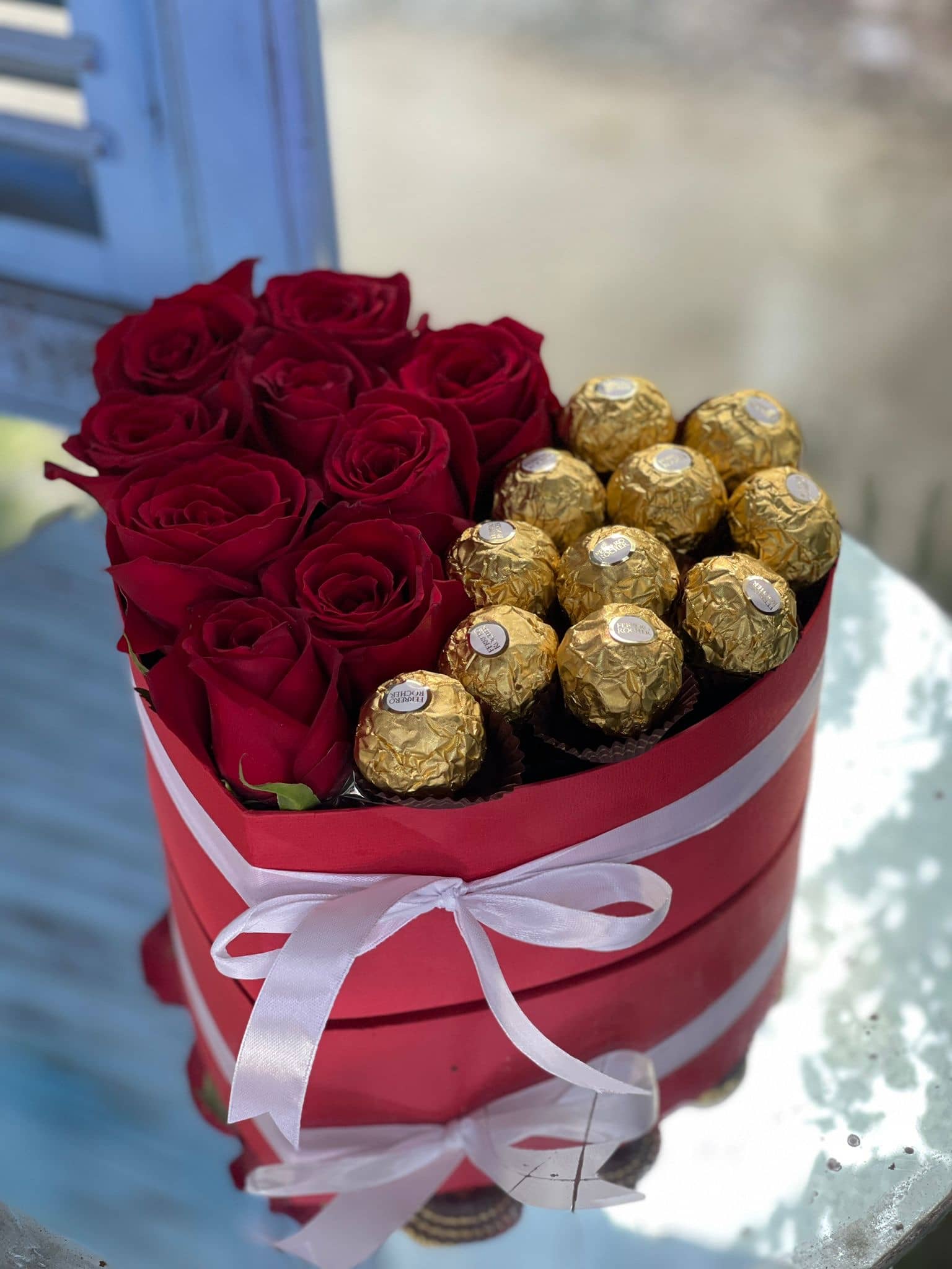 Коробка в форме сердца, содержащая 9 красных роз и 11 конфет.